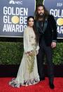 Jason Momoa is wearing a velvet tuxedo while Lisa Bonet chose a sheer floral gown. <em>[Photo: Getty]</em>