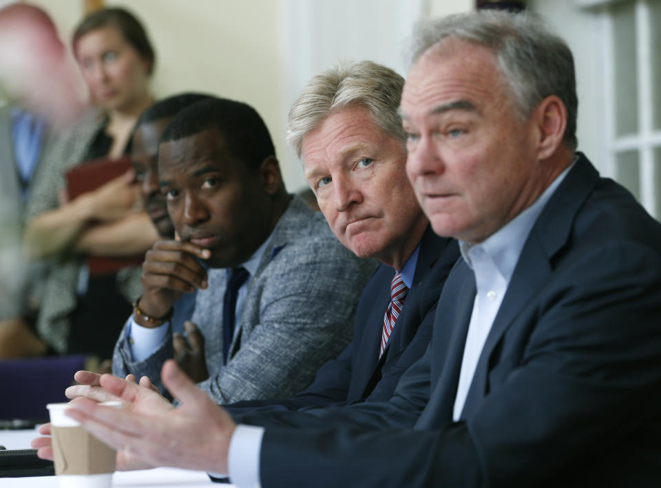 U.S. Sen. Tim Kaine, D-Va., right, gestures during a gun violence prevention roundtable discussion along with Richmond Mayor Levar Stoney, left, and Virginia Secretary of Public Safety, Brian Moran, center, in Richmond, Va., Monday, June 17, 2019. (AP Photo/Steve Helber)
