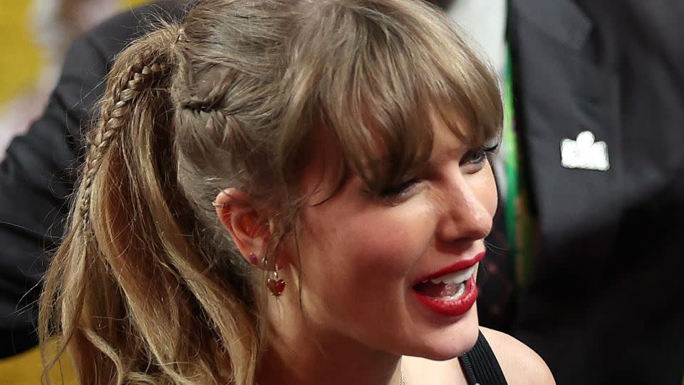 Taylor Swift arrived in a decidedly more muted look, finished off by lashings of sentimental jewellery – including her '87' necklace in honor of Kelce's jersey number. - Harry How/Getty Images
