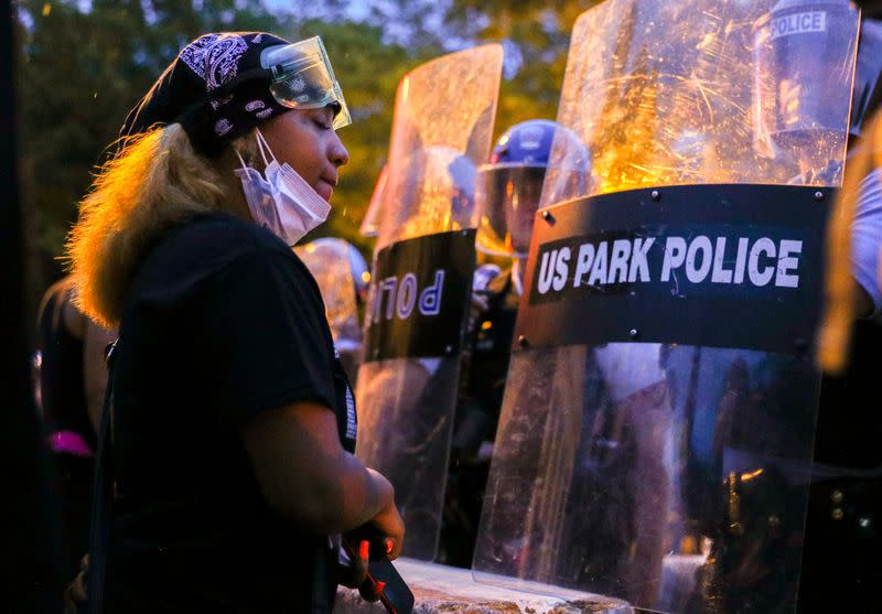 Protestors and police face off by the White House after clashes between police and protestors attempting to pull down statue of U.S. President Andrew Jackson in Washington