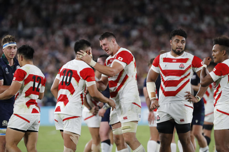 Japan's Luke Thompson, center right, celebrates with teammates after winning over Scotland in the Rugby World Cup Pool A game at International Stadium in Yokohama, Japan, Sunday, Oct. 13, 2019. (AP Photo/Eugene Hoshiko)