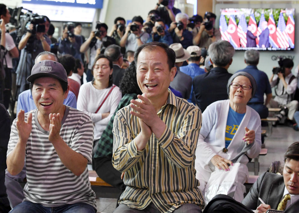 <p>At the Seoul Railway Station, people celebrate as they watch the news of President Trump meeting with North Korean leader Kim Jong Un on Tuesday. (Photo: Kyodo News via AP) </p>