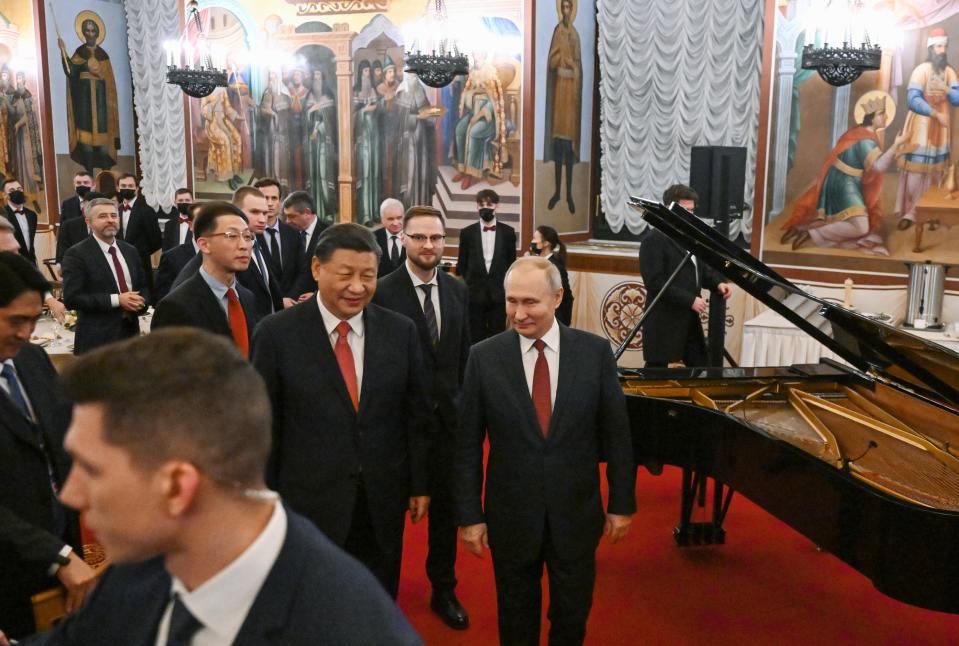 Chinese President Xi Jinping, center left, and Russian President Vladimir Putin, right, walk after their dinner at The Palace of the Facets in the Moscow Kremlin, Russia, Tuesday, March 21, 2023. (Grigory Sysoyev, Sputnik, Kremlin Pool Photo via AP)