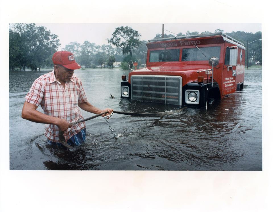 An overflow from McCoys Creek on King Street in October 1994 shows the chronic flooding that residents along the creek have suffered over the years. The city is working on a plan to move water through the creek in a way that will reduce the risk of flooding on neighborhood streets and homes.