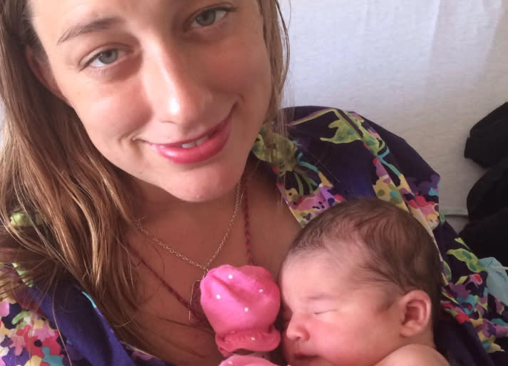 This mom shared a photo of herself breastfeeding her baby in a unique way for a *very* important reason