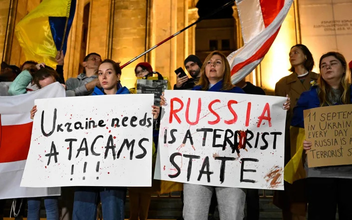Demonstrators protest against Russian strikes on Ukraine during a rally organised by Ukrainian refugees and activists, in Tbilisi - Vano Shlamov/AFP via Getty Images