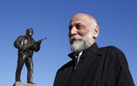 Sculptor Salavat Shcherbakov gives an interview near his creation, a monument to Russian designer of the AK-47 assault rifle Mikhail Kalashnikov, in Moscow, Russia September 22, 2017. REUTERS/Sergei Karpukhin