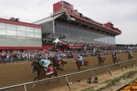 FILE - National Treasure, bottom left, with John Velazquez, leads the pack toward the first turn during the148th running of the Preakness Stakes horse race at Pimlico Race Course, May 20, 2023, in Baltimore. Maryland Gov. Wes Moore signed a measure on Thursday, May 9, 2024, to rebuild Baltimore’s historic but antiquated Pimlico Race Course and transfer the track to state control. (AP Photo/Julia Nikhinson, File)