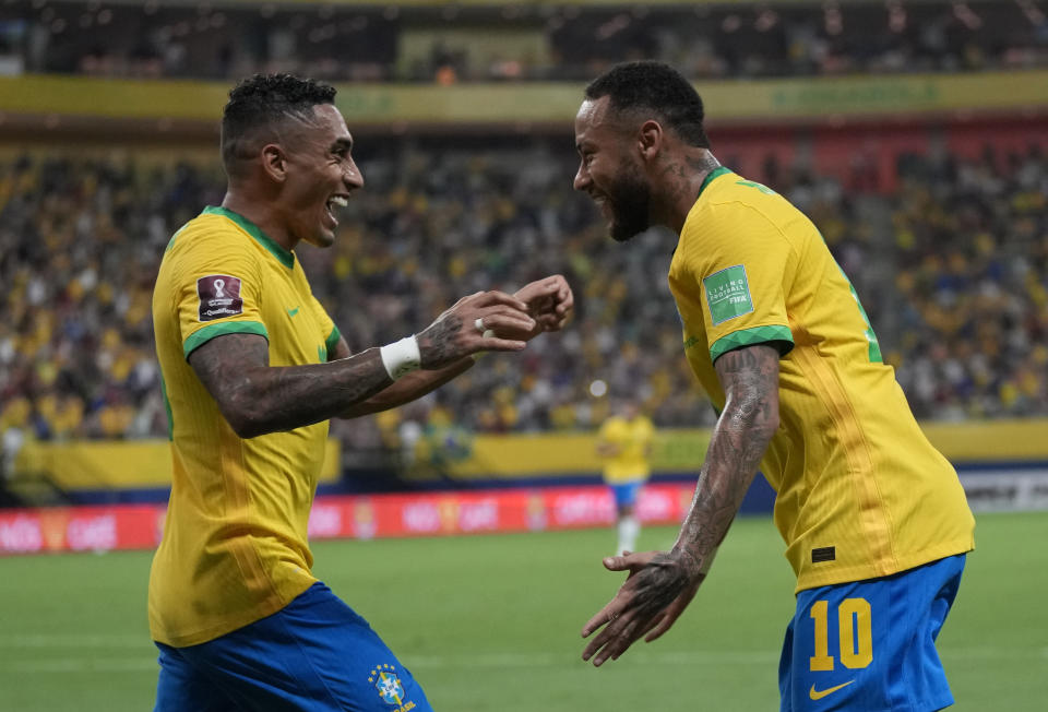 Brazil's Raphinha, left, celebrates with Brazil's Neymar after scoring his side's second goal against Uruguay during a qualifying soccer match for the FIFA World Cup Qatar 2022 at Arena da Amazonia in Manaus, Brazil, Thursday, Oct.14, 2021. (AP Photo/Andre Penner)