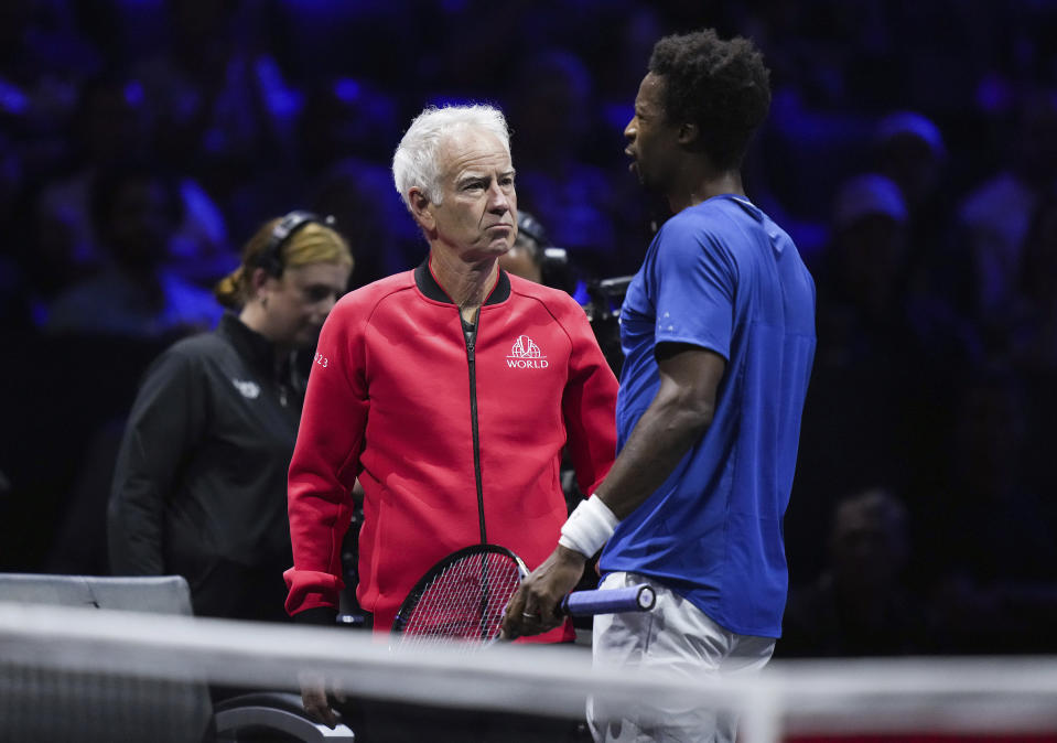 Team Europe's Gael Monfils, right, speaks to team captain John McEnroe during a changeover in a Laver Cup match against Team World's Felix Auger-Aliassime on Friday, Sept. 22, 2023, in Vancouver, British Columbia. (Darryl Dyck/The Canadian Press via AP)