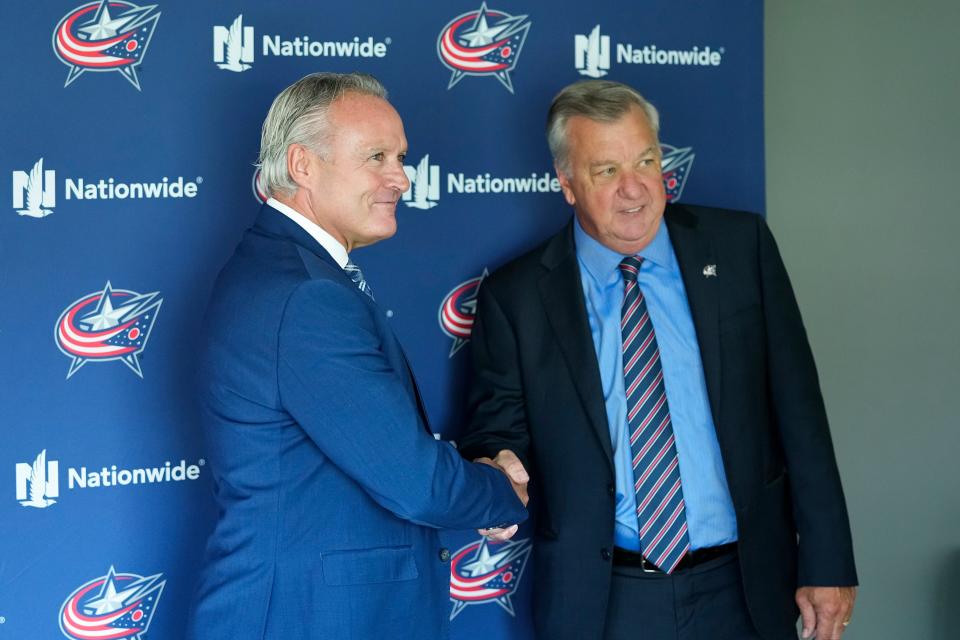 Jul 23, 2024; Columbus, OH, USA; New head coach of the Columbus Blue Jackets Dean Evason shakes hands with general manager Don Waddell after being introduced at a press conference at Nationwide Arena.