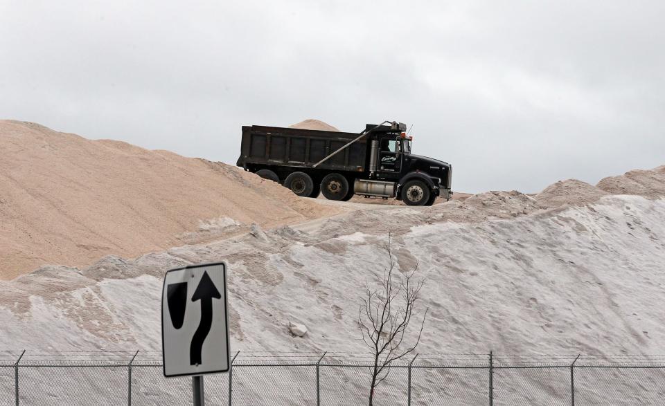 A dump truck is at the top of a mountain of salt in Portsmouth Monday, March 13, 2023, as another winter storm is predicted to hit the area Tuesday.