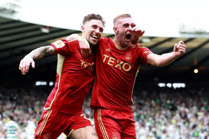 Aberdeen's Angus MacDonald (left) celebrates with team-mate Killian Phillips after scoring their side's third goal