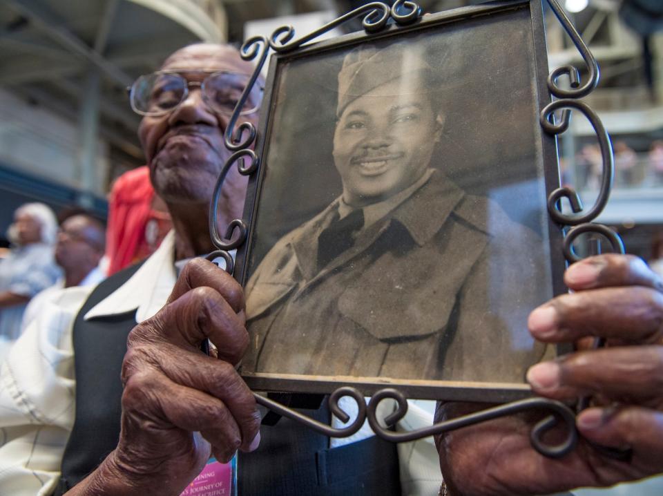 Brooks at the National World War II Museum in 2019 with his own military portrait.