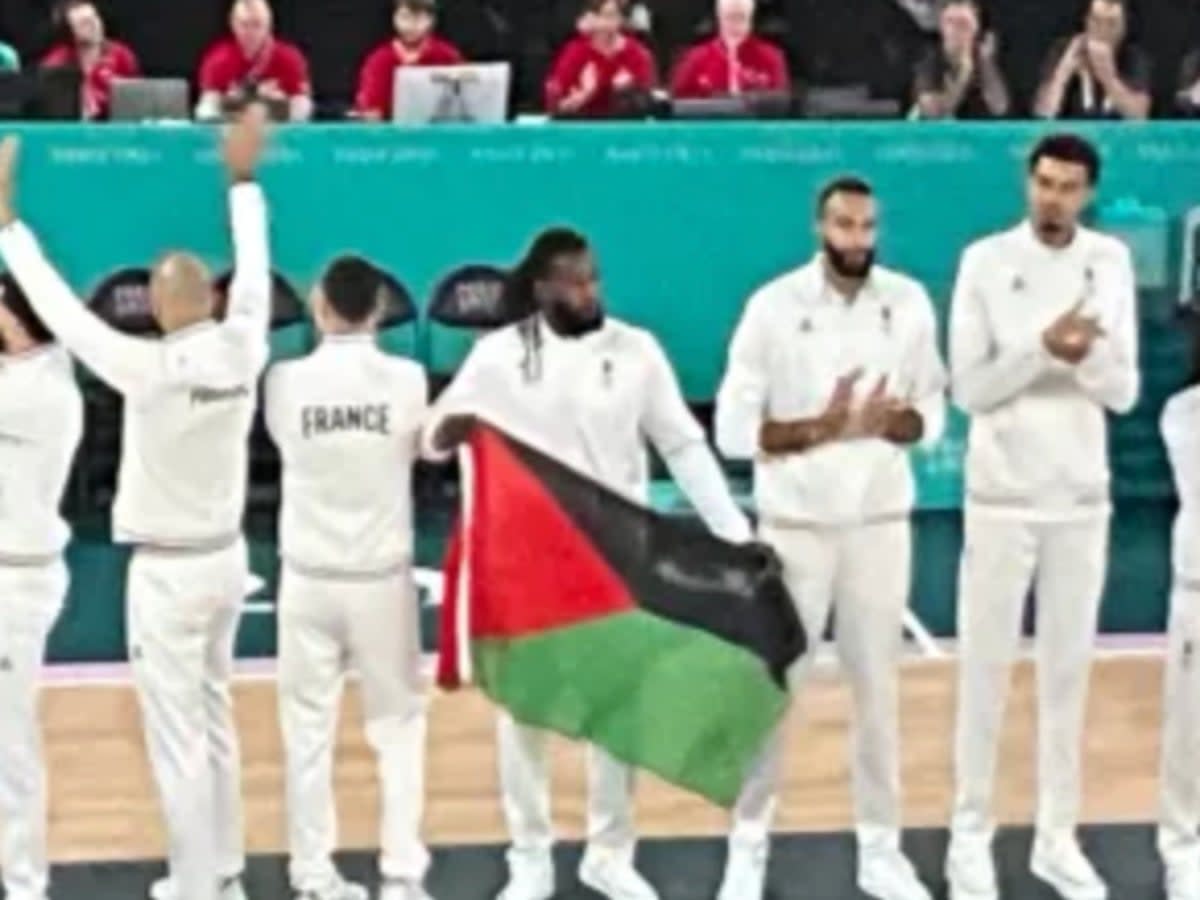 French basketball player Mathias Lessort draped Martinique flag around his shoulders – but it was mistaken for a Palestine flag by commentator Mike Tirico (NBC)