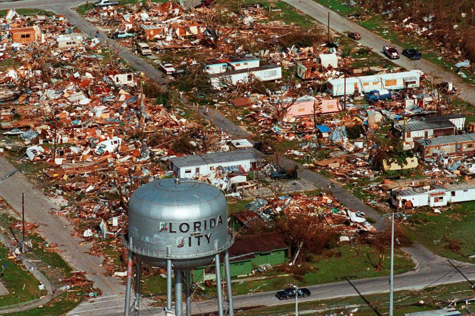 a water tower that says florida city is the only structure left standing in this aerial view of flattened buildings from hurricane andrew
