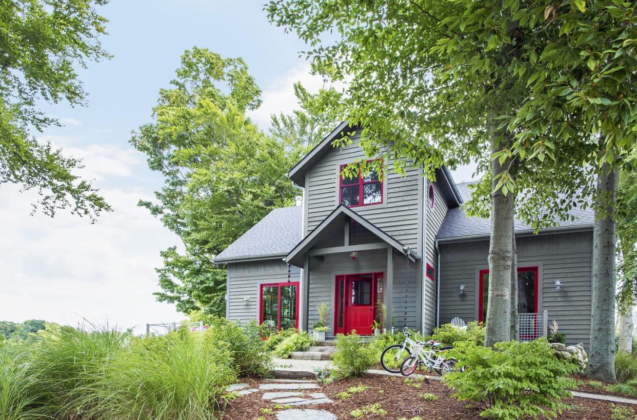 light grey house with bright red door and window frames