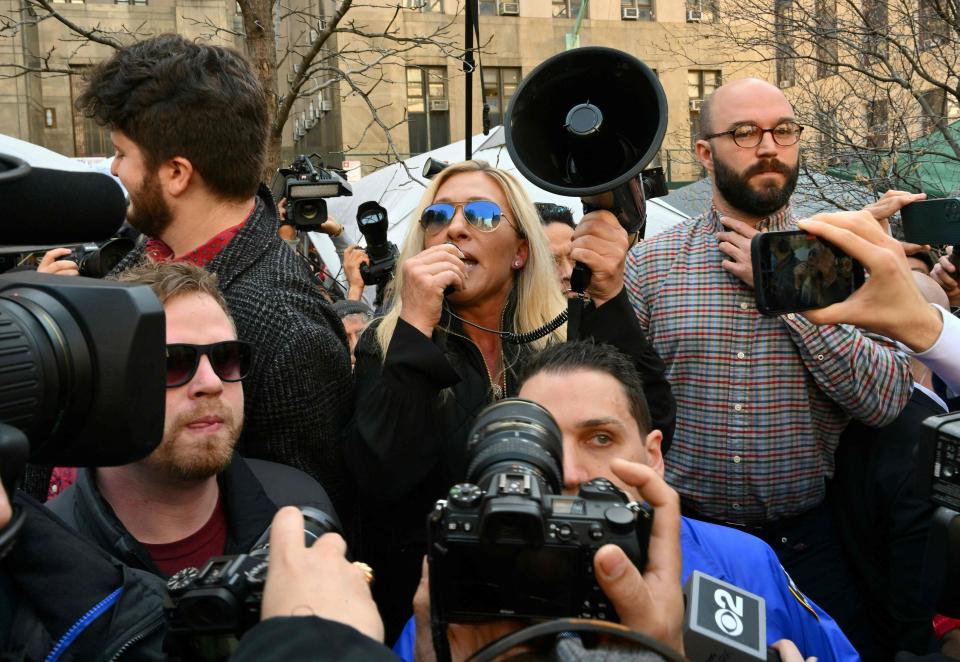 Rep. Marjorie Taylor Green, R-Ga., talks to supporters of former US President Donald Trump outside the District Attorneys office in New York on April 4, 2023.