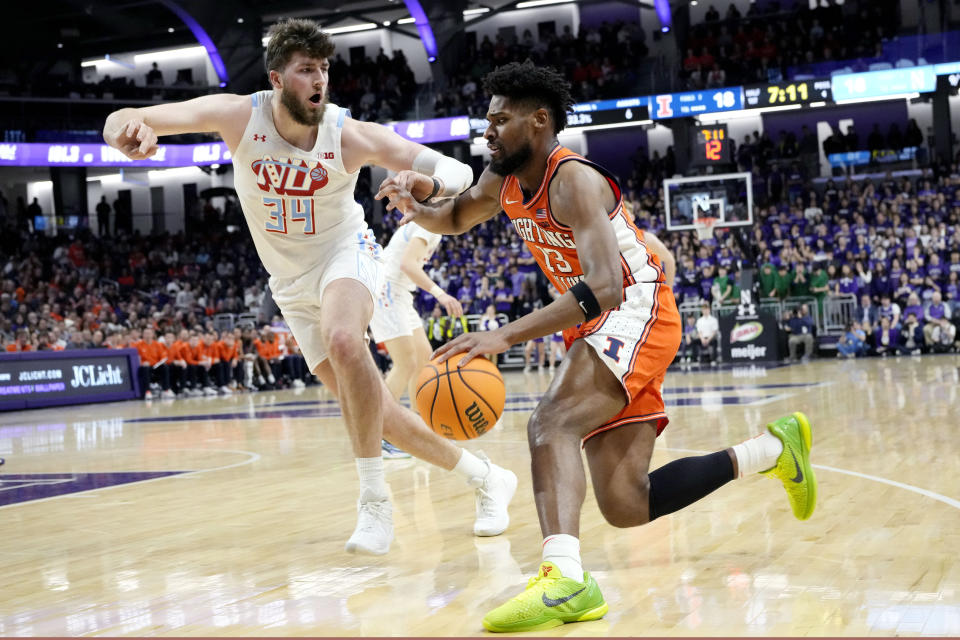 Illinois forward Quincy Guerrier, right, drives as Northwestern center Matthew Nicholson defends during the first half of an NCAA college basketball game in Evanston, Ill., Wednesday, Jan. 24, 2024. (AP Photo/Nam Y. Huh)