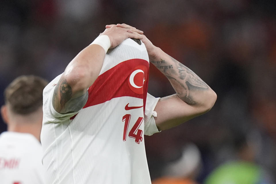 Turkey's Abdulkerim Bardakci pulls his shirt over his head after the end of the quarterfinal match between the Netherlands and Turkey at the Euro 2024 soccer tournament in Berlin, Germany, Saturday, July 6, 2024. The Netherlands won the game 2-1. (AP Photo/Matthias Schrader)