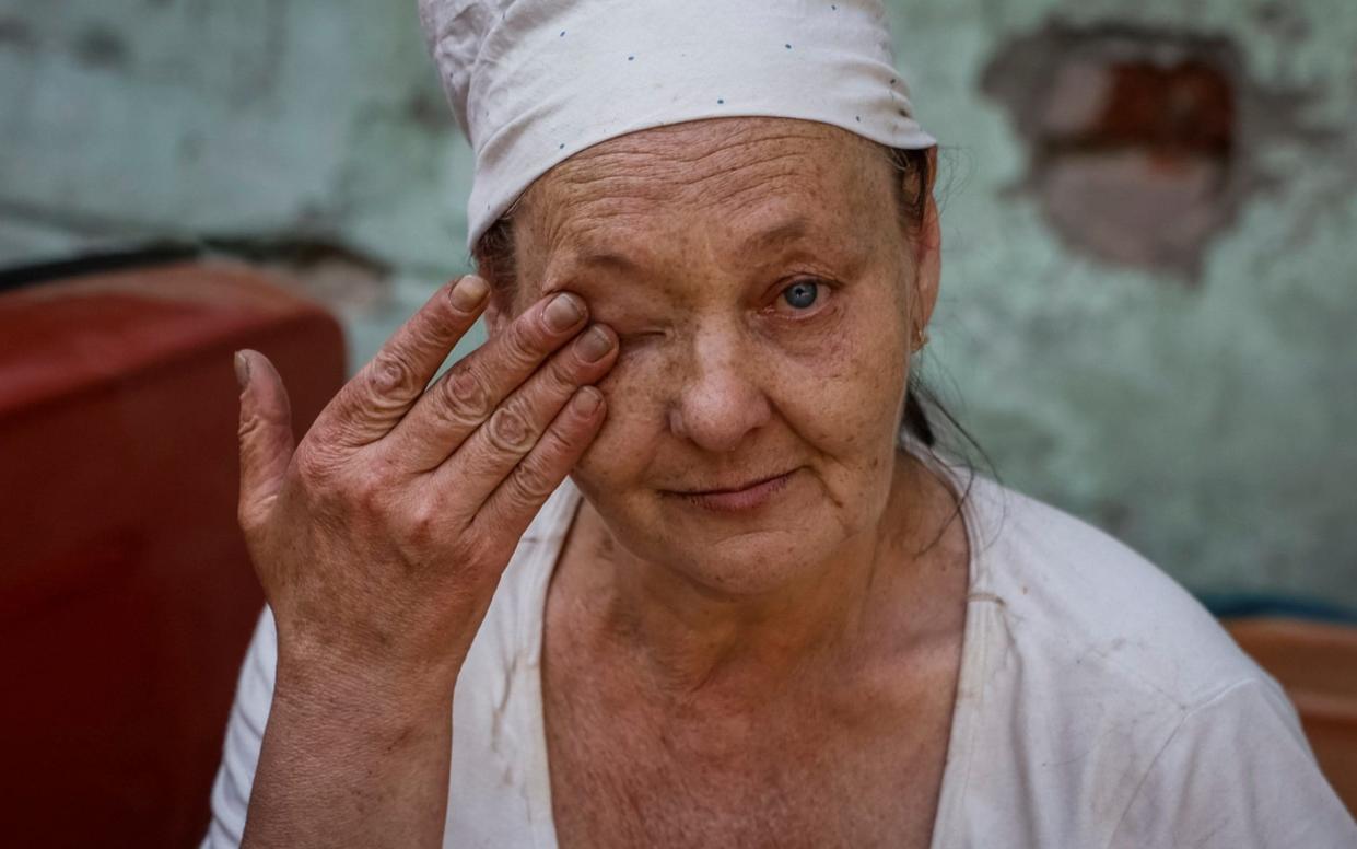 Nataliia, 56, cries as she waits for evacuation in the town of Toretsk that is being targeted by Russian bombs and shelling