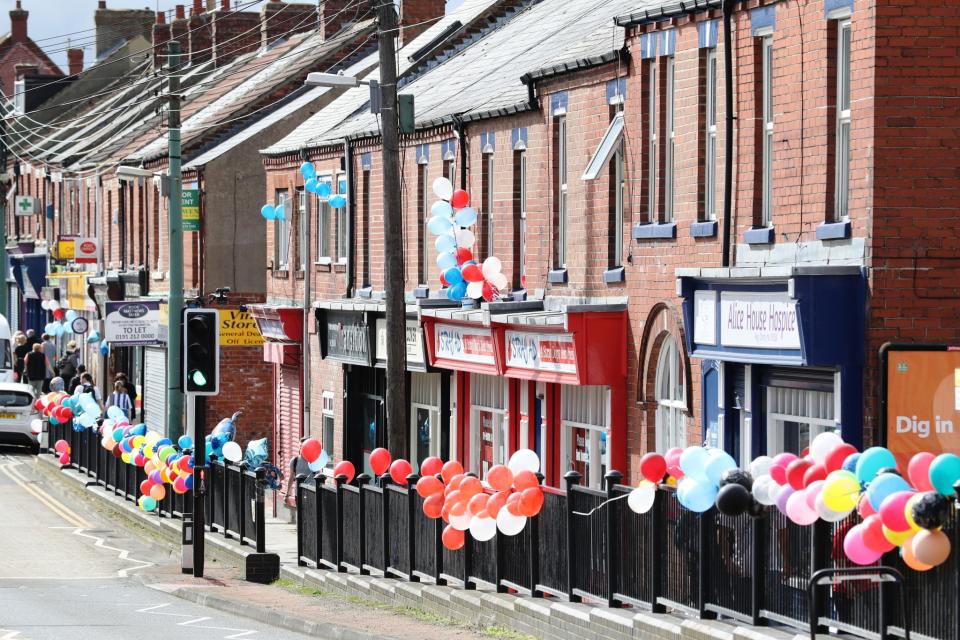 <p>People line the route of the funeral procession with decorations ahead of the funeral of Bradley Lowery, the six-year-old football mascot whose cancer battle captured hearts around the world </p>