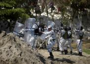 Members of Mexico's National Guard hold their shields to block migrants, part of a caravan travelling to the U.S., near the border between Guatemala and Mexico, in Ciudad Hidalgo