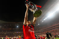 Benfica's Oscar Cardozo, from Paraguay, lifts the trophy celebrating at the end of their Portuguese league soccer match with Olhanense on Sunday April 20, 2014, at Benfica's Luz stadium in Lisbon. Benfica defeated Olhanense 2-0 to win the championship with two rounds left to play. (AP Photo/Francisco Seco)