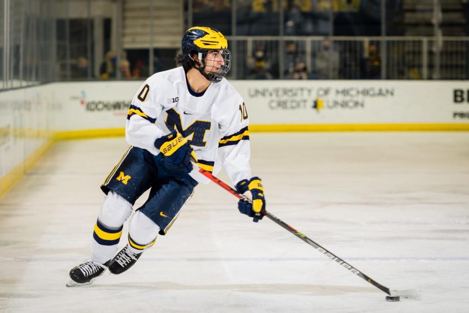 Matty Beniers carries the puck in a game against Michigan State on Jan. 8, 2021.