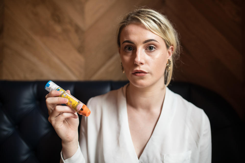 Amelia Bates, a university student from Manchester, suffered anaphylactic shock after she drank a cocktail made with egg whites. She's seen here holding an EpiPen.