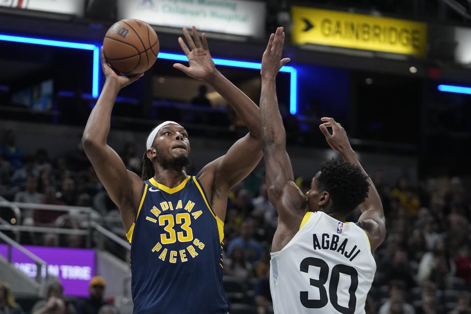 Indiana Pacers' Myles Turner (33) shoots over Utah Jazz's Ochai Agbaji (30) during the first half of an NBA basketball game, Wednesday, Nov. 8, 2023, in Indianapolis. (AP Photo/Darron Cummings)