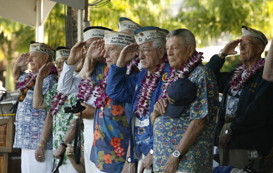 Pearl Harbor survivors salute as the USS Halsey passes the Arizona Memorial during the 72nd anniversary of the attack on Pearl Harbor at the WW II Valor in the Pacific National Monument in Honolulu, Hawaii on December 7, 2013. (REUTERS/Hugh Gentry)