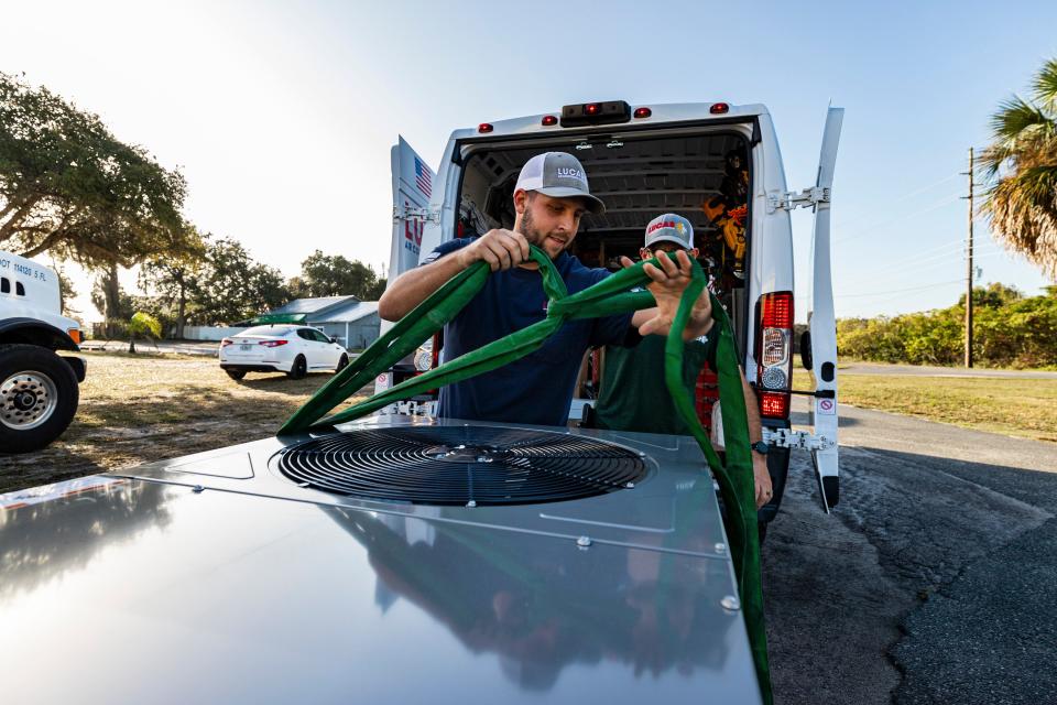 Cameron Lucas prepares the air conditioning unit for installation at the Mount Dora VFW. [submitted] cindy peterson