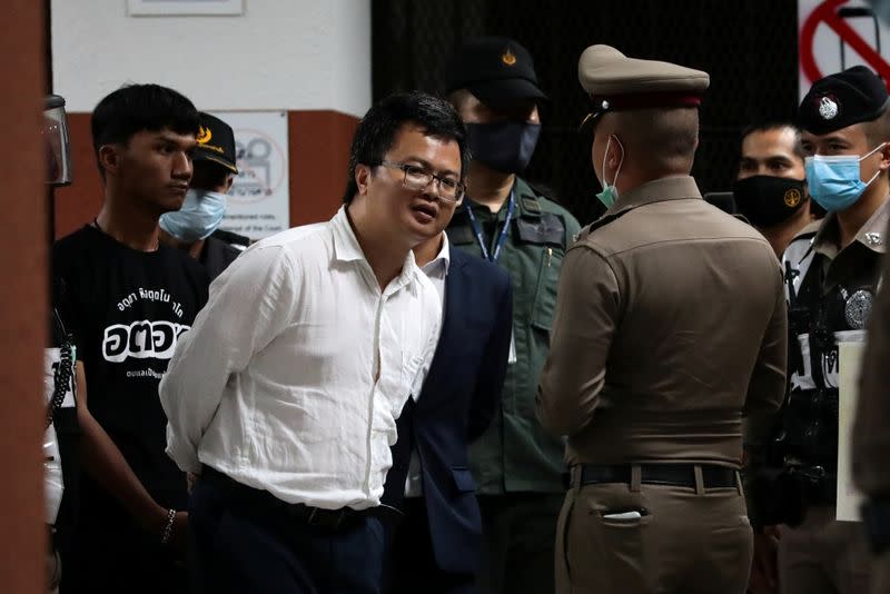 Anon Nampa and Panupong Jadnok (L) , pro-democracy students, and leaders of Thailand's recent anti-government protests, are pictured after being detained, while being transfer to the criminal court in Bangkok