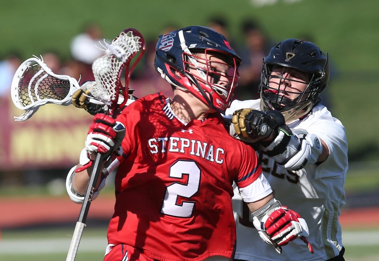 Stepinac's PJ Hodge (2) gets pressured from Iona's Blaise New (11) during boys lacrosse action at Iona Prep in New Rochelle  April 18, 2023. Stepinac won the game 9-7.