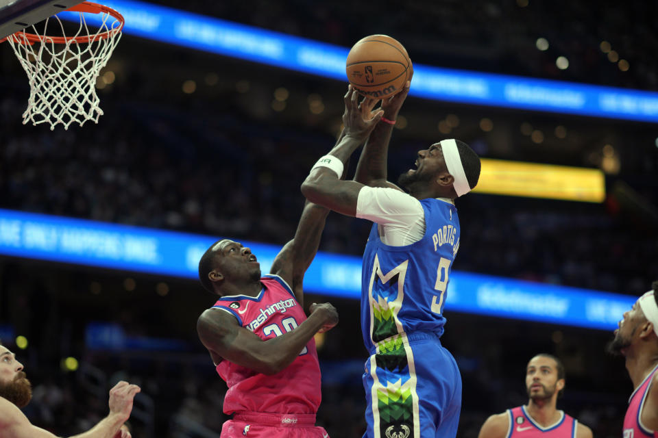 Milwaukee Bucks forward Bobby Portis (9) goes up against Washington Wizards guard Kendrick Nunn (20) during the first half of an NBA basketball game, Tuesday, April 4, 2023, in Washington. (AP Photo/Jess Rapfogel)