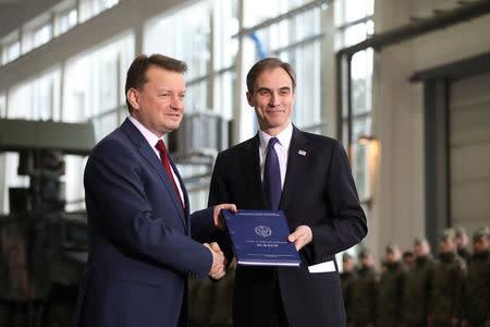 Polish Defence Minister Mariusz Blaszczak and U.S. Ambassador to Poland Paul W. Jones attend the signing ceremony for a deal to buy Raytheon Co's Patriot missile defence system in Warsaw, Poland, March 28, 2018. Agencja Gazeta/Slawomir Kaminski/ via REUTERS