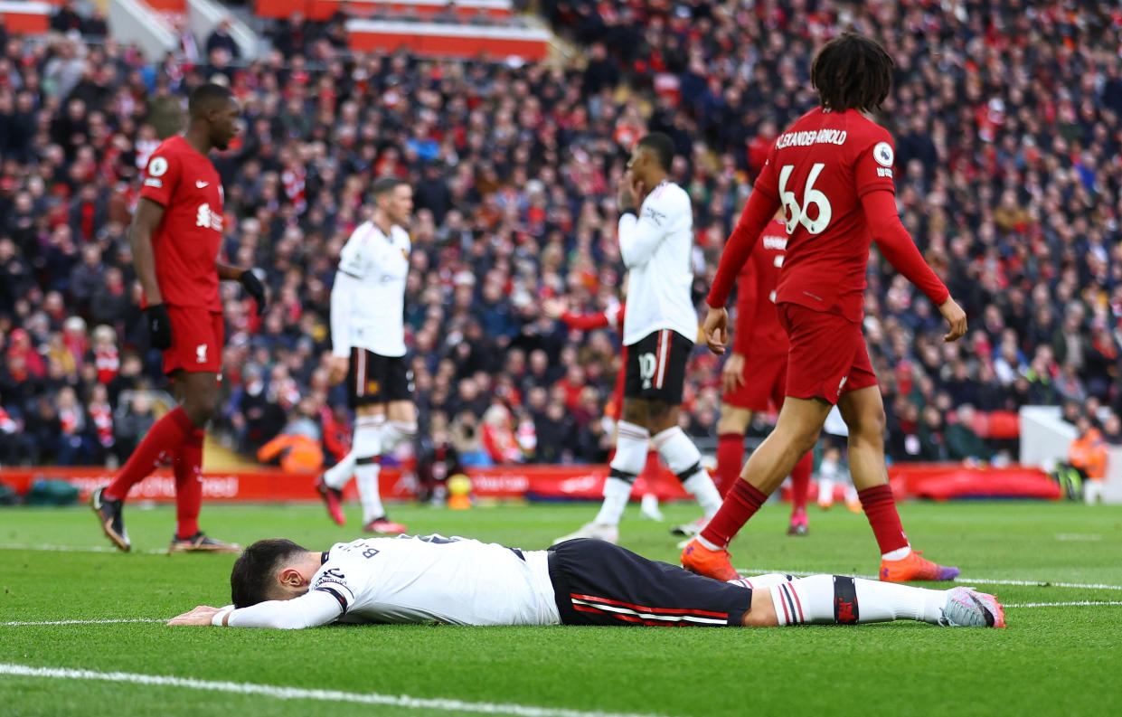 Manchester United's Bruno Fernandes lies on the ground during their 0-7 thrashing by Liverpool in the English Premier League.