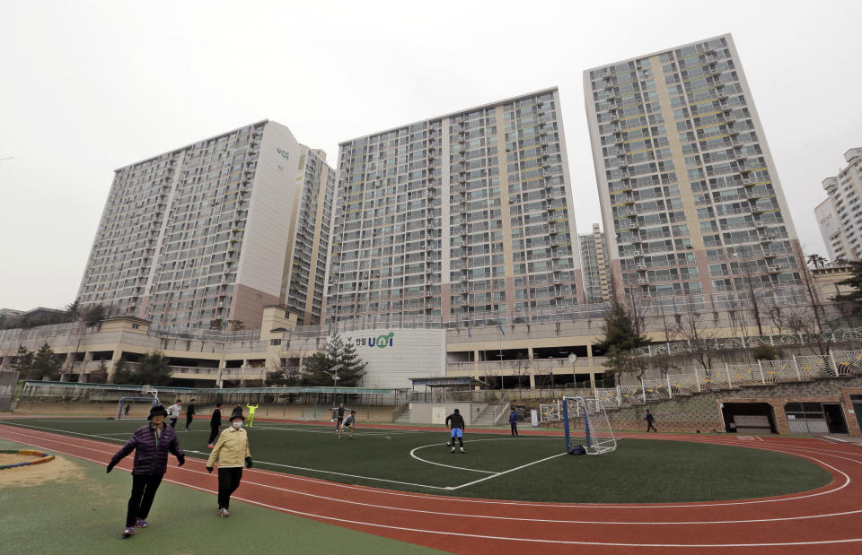 FILE - In this Jan. 28, 2016, file photo, residents exercise as at a school near an apartment complex at the former location of the Brothers Home, a mountainside institution where some of the worst human rights atrocities in modern South Korean history took place, in Busan, South Korea. South Korea's top public prosecutor on Tuesday apologized over what he described as a botched investigation into the enslavement and mistreatment of thousands of people at a vagrants' facility in the 1970s and 1980s nearly three decades after its owner was acquitted of serious charges. (AP Photo/Ahn Young-joon, File)