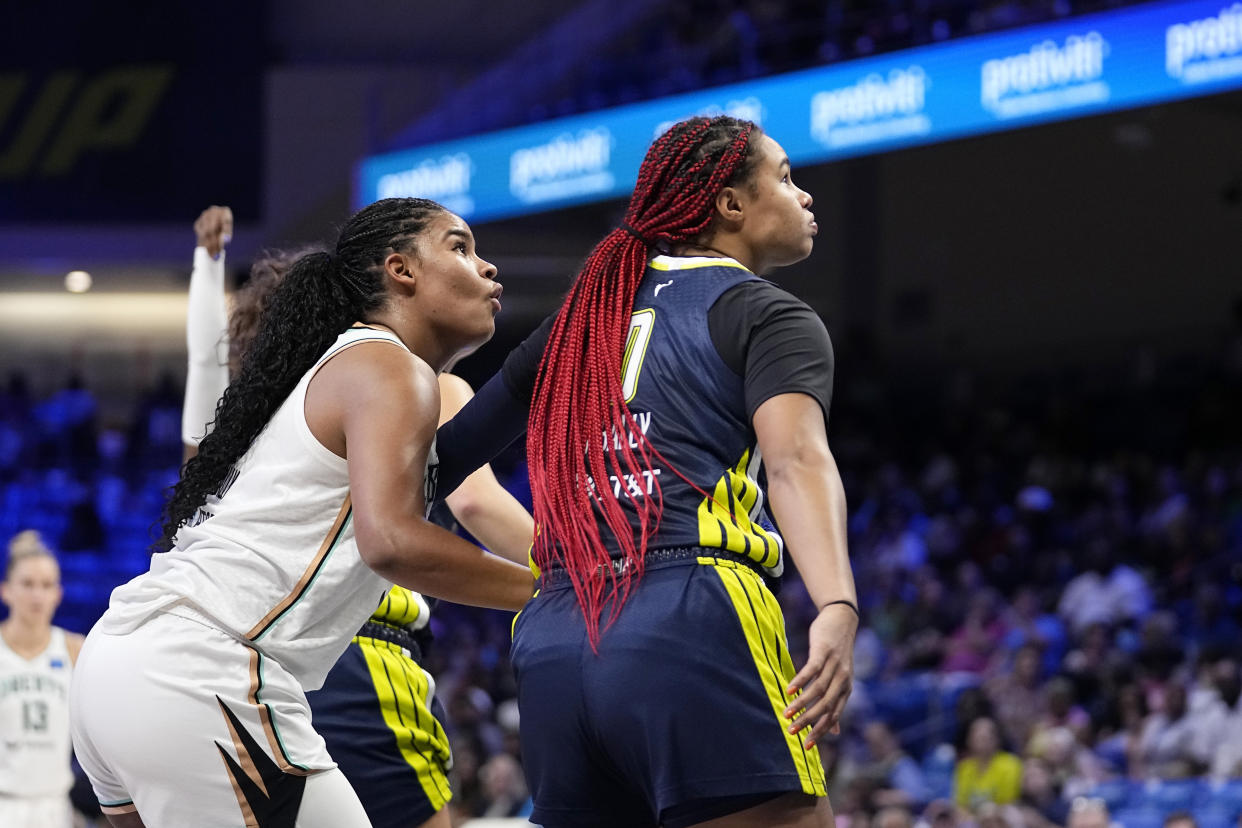 New York Liberty's Nyara Sabally, left, and her sister Dallas Wings' Satou Sabally, right, defend during Liberty free throws in the second half of a WNBA basketball game, Thursday, Sept. 12, 2024, in Arlington, Texas. (AP Photo/Tony Gutierrez)