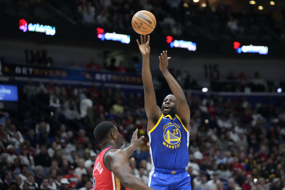 Golden State Warriors forward Draymond Green (23) shoots 0ver New Orleans Pelicans forward Zion Williamson (1) in the first half of an NBA basketball game in New Orleans, Monday, Oct. 30, 2023. (AP Photo/Gerald Herbert)