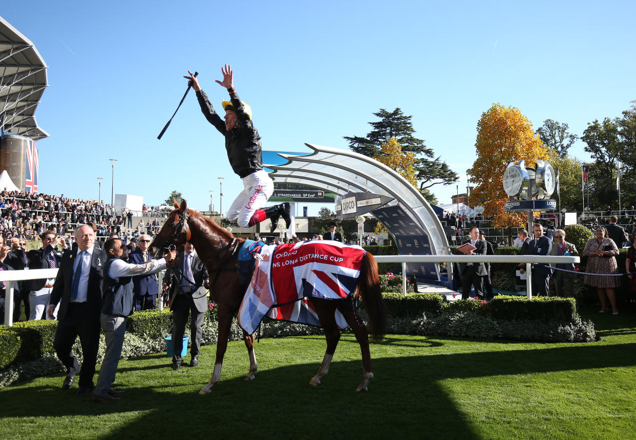 Frankie Dettori with his usual flying dismount after Stradivarius lands the Long Distance Cup