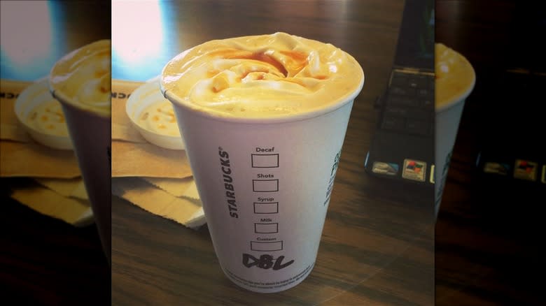 dark barrel latte on table