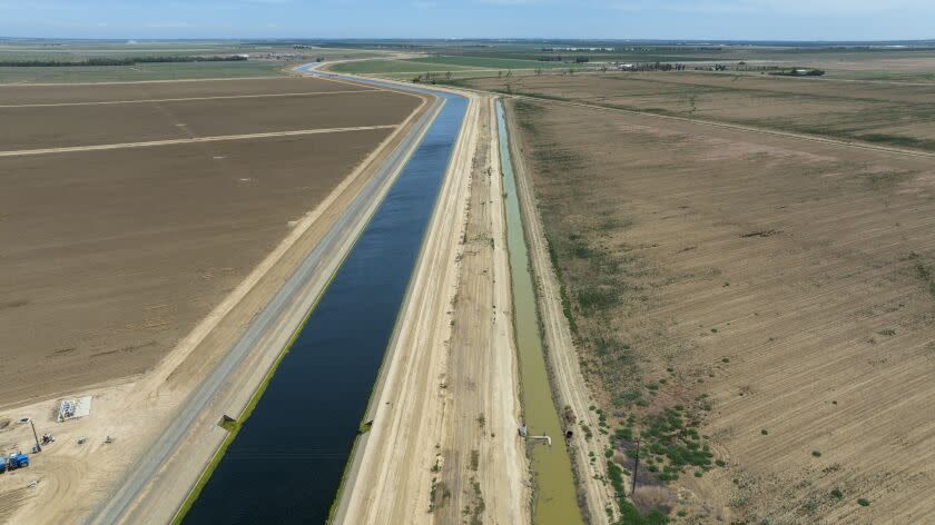 Firebaugh, CA - June 03: The Delta-Mendota Canal, left, and a parallel canal under the Panoche Water District's control, right, on Friday, June 3, 2022 in Firebaugh, CA. In April the U.S. Attorney's office charged the head of the Panoche Water District with stealing 25 million dollars worth of water out of the Delta Mendota Canal exploiting a leak in the canal where he engineered a way to steal water from the federal Central Valley Project. (Brian van der Brug / Los Angeles Times)