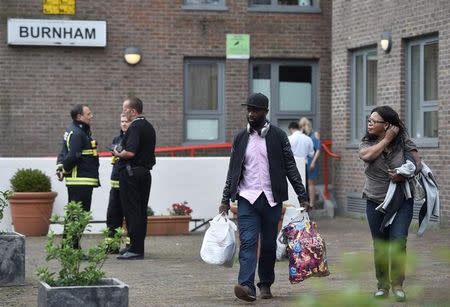 Residents are evacuated from the Burnham Tower residential block as a precautionary measure following concerns over the type of cladding used on the outside of the building on the Chalcots Estate in north London, Britain, June 24, 2017. REUTERS/Hannah McKay