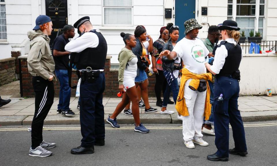 Police stop and search people during the Notting Hill Carnival in London, August 2018. 