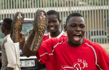 African migrants show off cleated shoes used for climbing the border fence after arriving at the CETI, the short-stay immigrant centre, after crossing the border from Morocco to Spain's North African enclave of Melilla, Spain, June 26, 2016. REUTERS/Jesus Blasco de Avellaneda