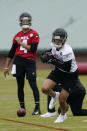 Atlanta Falcons first round draft pick wide receiver Drake London runs after catching a pass from quarterback Desmond Ridder during their NFL rookie minicamp football practice Friday, May 13, 2022, in Flowery Branch, Ga. (AP Photo/John Bazemore)