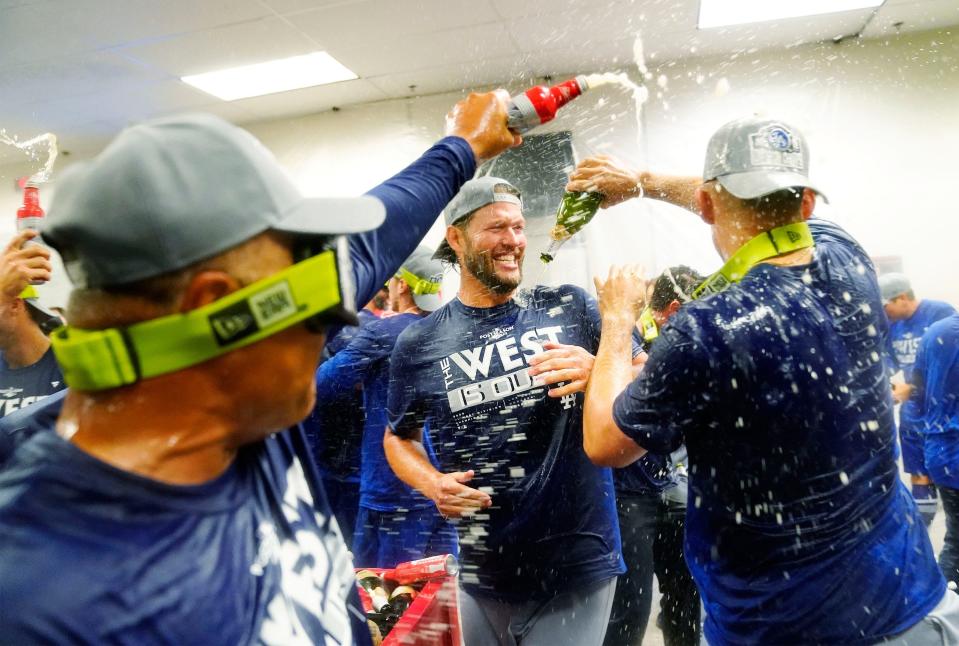 Dodgers players and coaches celebrate after clinching the NL West title.