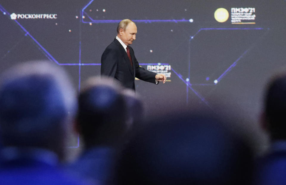 Russian President Vladimir Putin enters the hall during the St. Petersburg International Economic Forum in St. Petersburg, Russia, Friday, June 4, 2021. (Anatoly Maltsev/Pool Photo via AP)